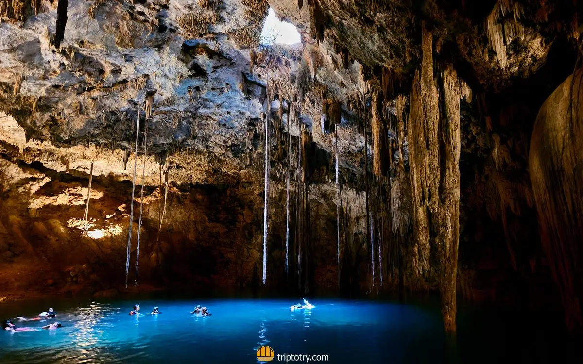 cenote Xkeken near Valladolid in Yucatan, a lake inside a cave with only a small crack through which the sun's rays enter